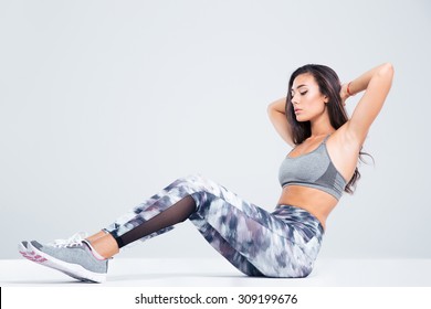 Portrait Of A Fitness Woman Doing Abs Exercises Isolated On A White Background