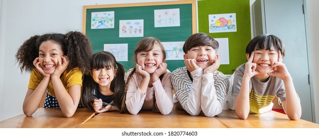 Portrait of five children having good time in classroom, asian caucasian children together in school background. Home school education, diversity multicultural community. Back to school concept