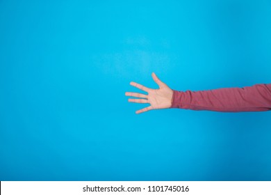 Portrait Of A Five Fingers In A Hand On A Blue Background.