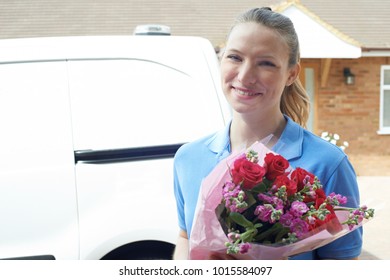 Portrait Of Florist Making Home Delivery Of Bouquet 