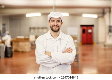 Portrait of a food factory and butcher worker smiling at the camera. - Powered by Shutterstock