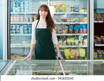 Portrait Of Food Store Employee Near Shelves With Products
