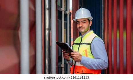 Portrait of Foreman checking inventory or task details at Container cargo harbor. Logistics concept inside the shipping, import, and export industries.