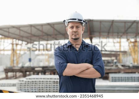 Portrait of foreman construction builder worker standing and wearing safety uniform, helmet at construction site