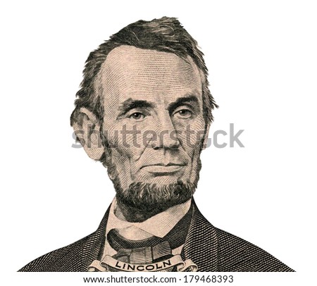Portrait of former U.S. president Abraham Lincoln as he looks on five dollar bill obverse. Clipping path inside. 