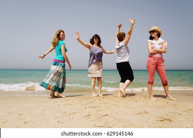 Portrait Of Four  40 Years Old Women Walking On Seaside