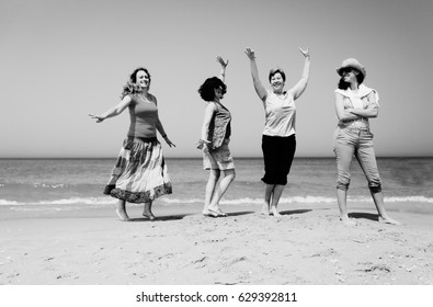 Portrait Of Four  40 Years Old Women Walking On Seaside