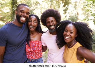 Portrait Of Four Black Adult Friends On A Walk In The Forest