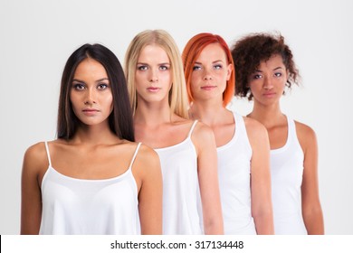 Portrait Of A Four Serious Women With Colourful Hair Standing In A Raw Isolated On A White Background