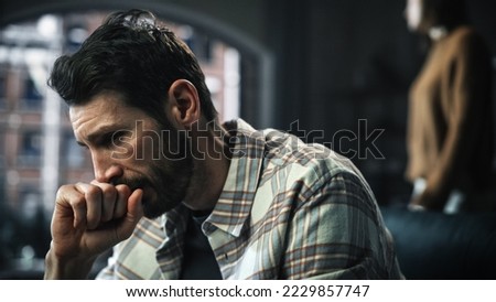 Portrait of Fragile Crying Man being Harrased and Bullied by Partner. Couple Arguing and Fighting Violently. Domestic Violence, Emotional Abuse, Toxic Behavior. Rack Focus with Girfriend Screaming
