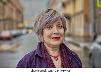 Portrait of friendly aged woman with color hair who walks outside. - Powered by Shutterstock