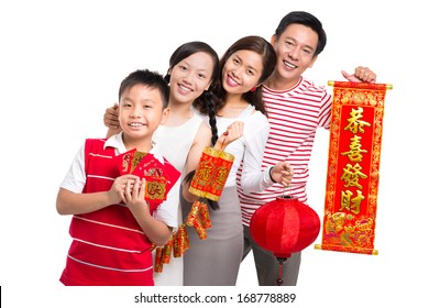 Portrait Of A Friendly Asian Family Wishing Happiness In The New Chinese Year Standing Against A White Background 