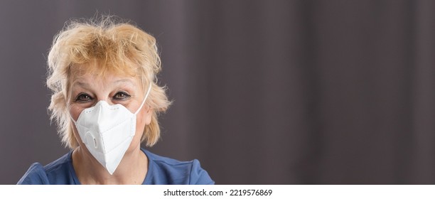 Portrait Of Friendly Caregiver Posing With Elderly Ill Woman Wearing Surgical Mask Because Of Covid-19 Pandemic