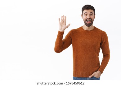 Portrait Of Friendly Cheerful Bearded Man Waving Hand At Camera, Saying Hi, Greeting Person With Happy Smile, Casual Meeting Of Friends, Hello Gesture, Standing White Background