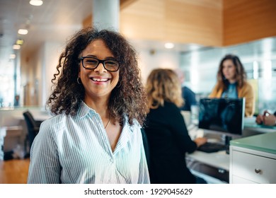 Portrait Of A Friendly Municipal Office Administrator. Mature Woman With Eyeglasses Looking At Camera And Smiling.