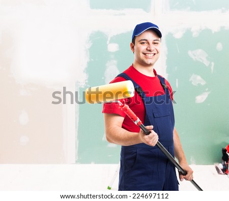 Portrait of a friendly painter at work in an apartment