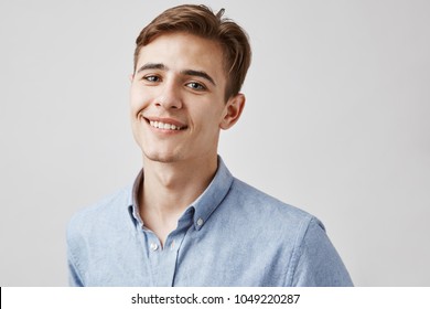 Portrait Of Friendly Young Man Inside. Trendy Handsome Guy Looks To The Camera Smiling And Wishing Everyone Of Us Worry Less And Enjoy More. Go And Call Your Friends. Invite Them And Have Fun.