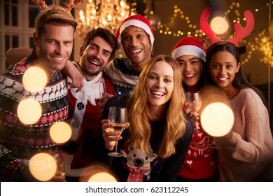 Portrait Of Friends In Festive Jumpers At Christmas Party