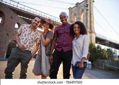 Portrait Of Friends Walking By Brooklyn Bridge In New York City