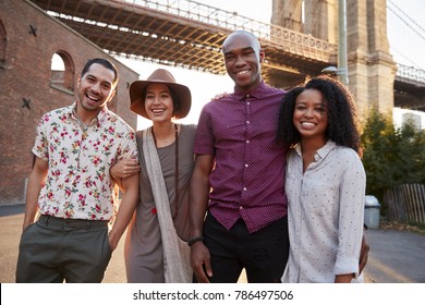 Portrait Of Friends Walking By Brooklyn Bridge In New York City