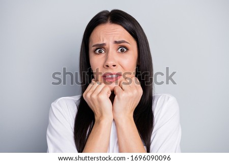 Portrait of frustrated anxious girl hear horrible corona virus novelty disease feel fear touch fists face chin wear good look outfit isolated over gray color background