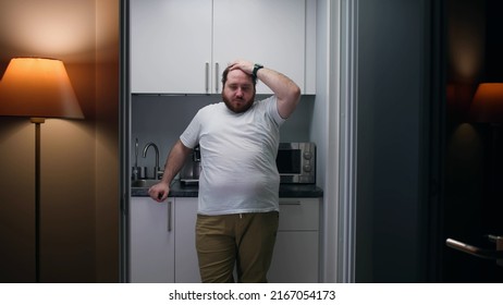 Portrait of frustrated overweight man stand in small kitchen. Stressed and worried fat guy cry at home - Shutterstock ID 2167054173