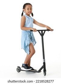 Portrait Full Body Studio Cutout Shot Of Asian Young Playful Cheerful Pigtail Braid Hair Girl Model In Blue Sleeveless Dress Standing Posing Riding Scooter Smiling Look At Camera On White Background.