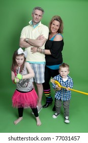 Portrait Of Fun Family Wearing Colorful 80's Costumes