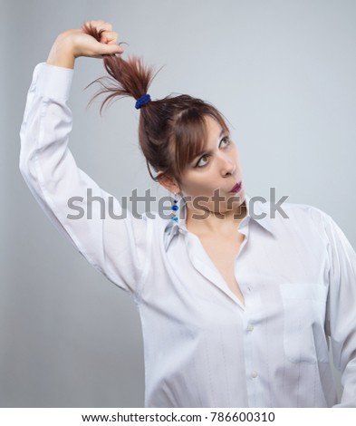 Portrait of fun woman pulling hair