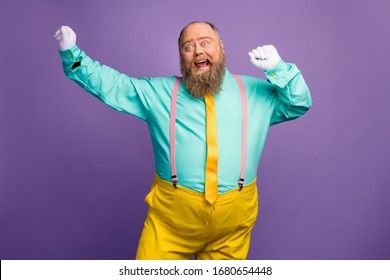 Portrait Of Funky Crazy Excited Fat Overweight Man Enjoy Party Discotheque Dancing Raise Fists White Gloves Wear Bright Outfit Isolated Over Violet Color Background