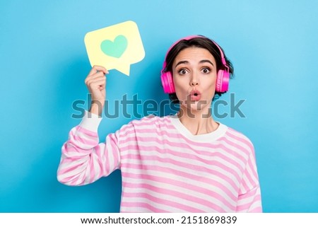 Portrait of funky funny impressed girl how like heart button enjoying favorite music isolated on blue color background