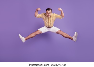 Portrait Of Funky Strong Guy Jump Show Big Biceps On Purple Background