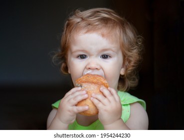 Portrait Of Funny Baby With Bread In Her Hands Eating. Cute Toddler Child Eating Sandwich, Self Feeding Concept