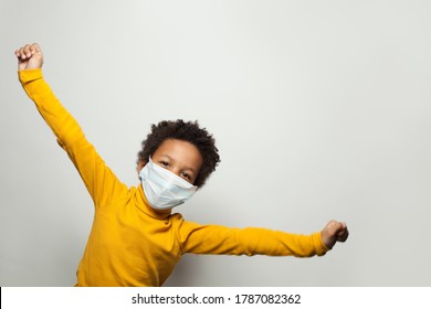 Portrait of funny black child boy in medical protective face mask having fun - Powered by Shutterstock
