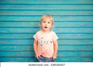 Portrait Of Funny Child. Happy Kid Having Fun At Home. Spring Family Holiday Concept. Mother's Day