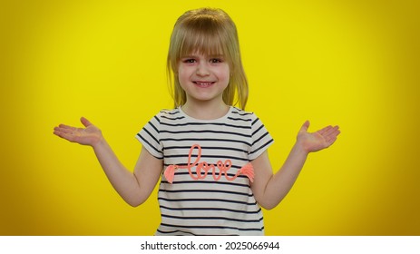 Portrait Of Funny Confused Blonde Child Girl Raising Hands In Indignant Expression, Asking Why, What Reason Of Failure, Demonstrating Disbelief Irritation By Troubles On Yellow Wall. Teen Kid Children