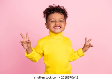 Portrait of funny dark skin person two hands fingers make v-sign toothy smile isolated on pink color background