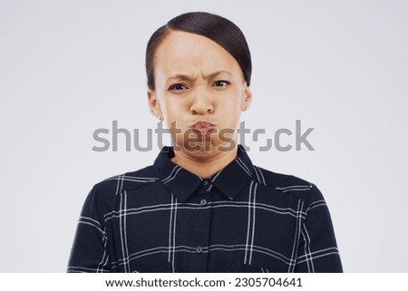 Portrait, funny face and breath with a woman in studio on a gray background looking silly or goofy. Comedy, comic and frown with a crazy young female person joking indoor for quirky fun or humor