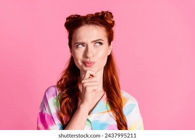 Portrait of funny gorgeous woman with foxy hairstyle wear print shirt tricky look at promo empty space isolated on pink color background