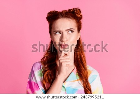 Portrait of funny gorgeous woman with foxy hairstyle wear print shirt tricky look at promo empty space isolated on pink color background