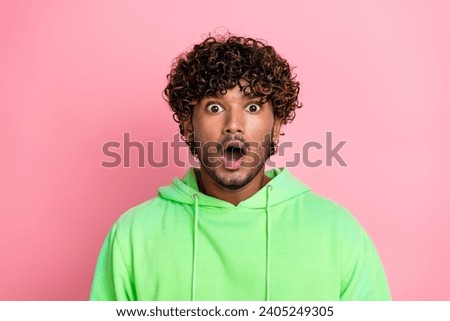 Portrait of funny guy in green hoodie shocked open mouth speechless when see the announcement fortnite isolated on pink color background