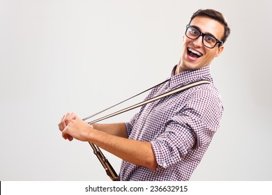 Portrait Of Funny Handsome Nerd Guy Pulling His Suspenders.