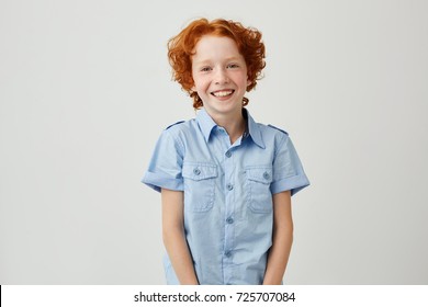 Portrait Of Funny Little Boy With Red Hair And Freckles Smiling Brightfully, Looking In Camera, Posing For Family Photo Album.