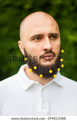 Portrait of funny man with decoration in his beard
