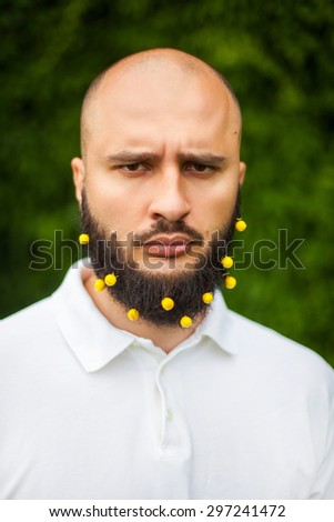 Portrait of funny man with decoration in his beard