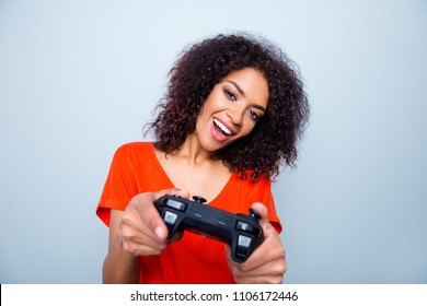 Portrait of funny playful woman with modern hairdo using joystick playing video game enjoying free time isolated on grey background - Powered by Shutterstock