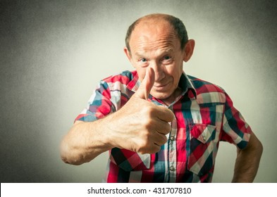 Portrait Of The Funny Senior Man Doing Thumbs Up