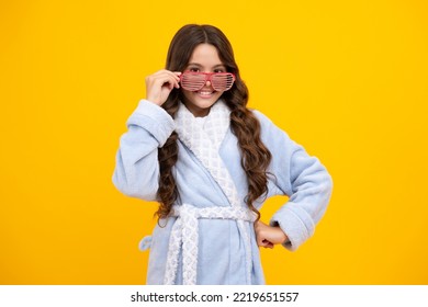 Portrait Of Funny Teenage Girl In Funny Glasses And Pajama Or Home Bathrobe Feeling Fun Isolated On Yellow Background.