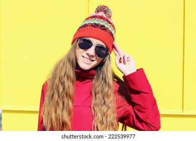 Portrait of a funny young girl in the autumn weather in warm clothes and hat. Photo toned style Instagram filters - Shutterstock ID 222539977