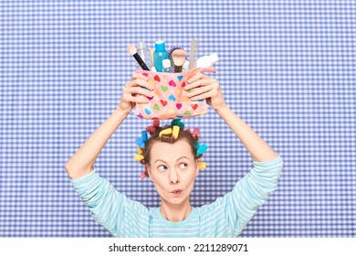 Portrait Of Funny Young Woman With Colorful Hair Curlers On Head, Holding Makeup Bag With Beauty Treatment Accessories And Cosmetics, Making Goofy Face, Fooling Arounds Over Shower Curtain Background